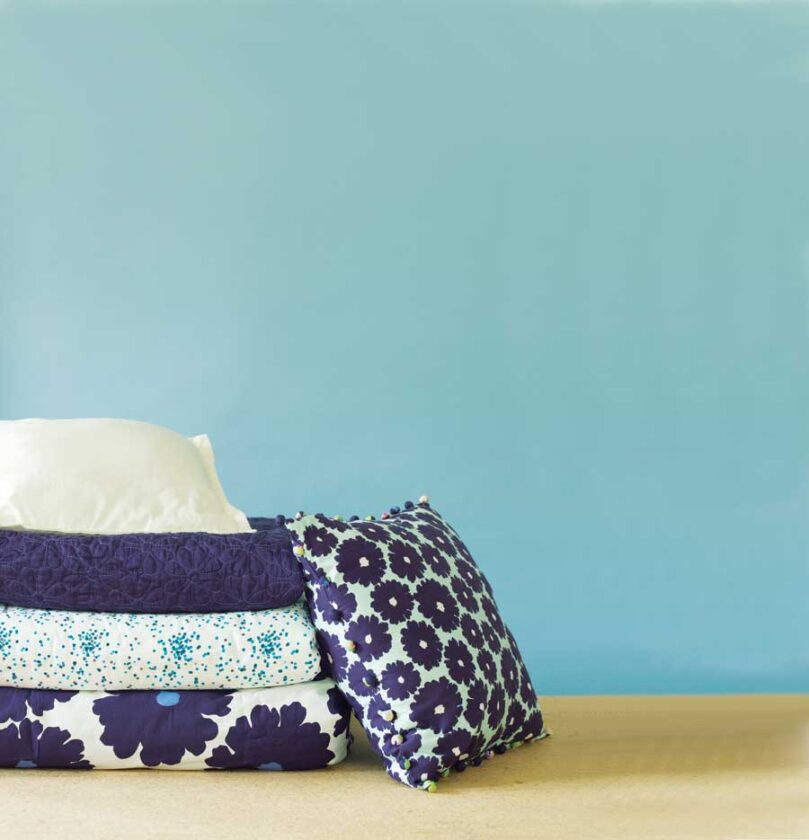 From top to bottom: Amy Butler's Dream Daisy coverlet, Plover Organic's Cartouche/Teal Confetti quilt, Amy Butler's Dream Daisy duvet, and Amy Butler's Dream Daisy square decorator pillow